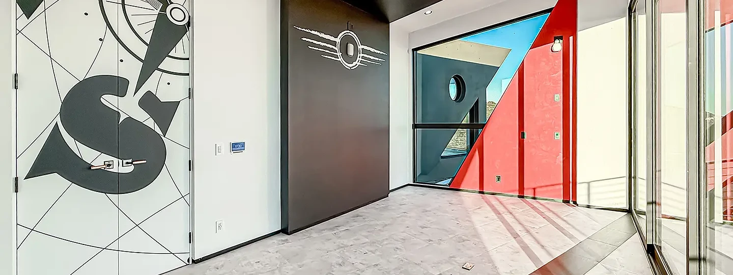 Hallway at The Aviator with graphic wall art and red accents