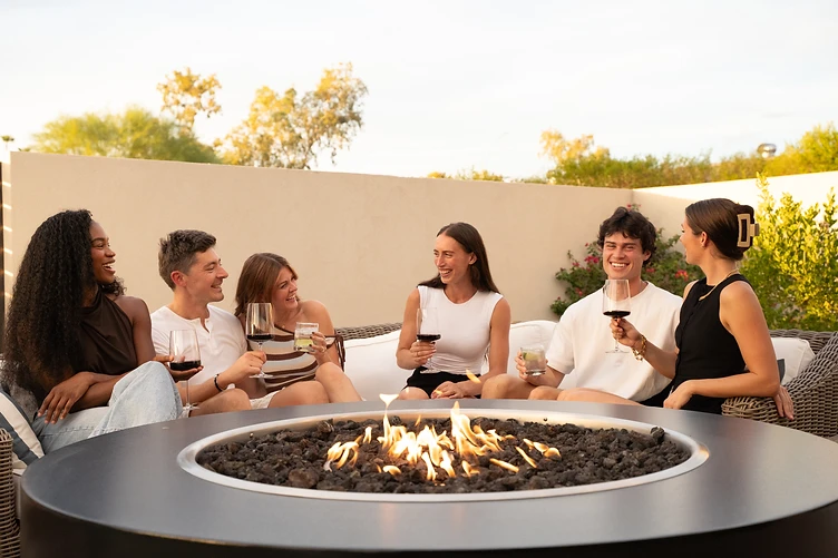 Guests gathered around the fire pit at Paradise Reserve, a North Scottsdale luxury vacation rental estate