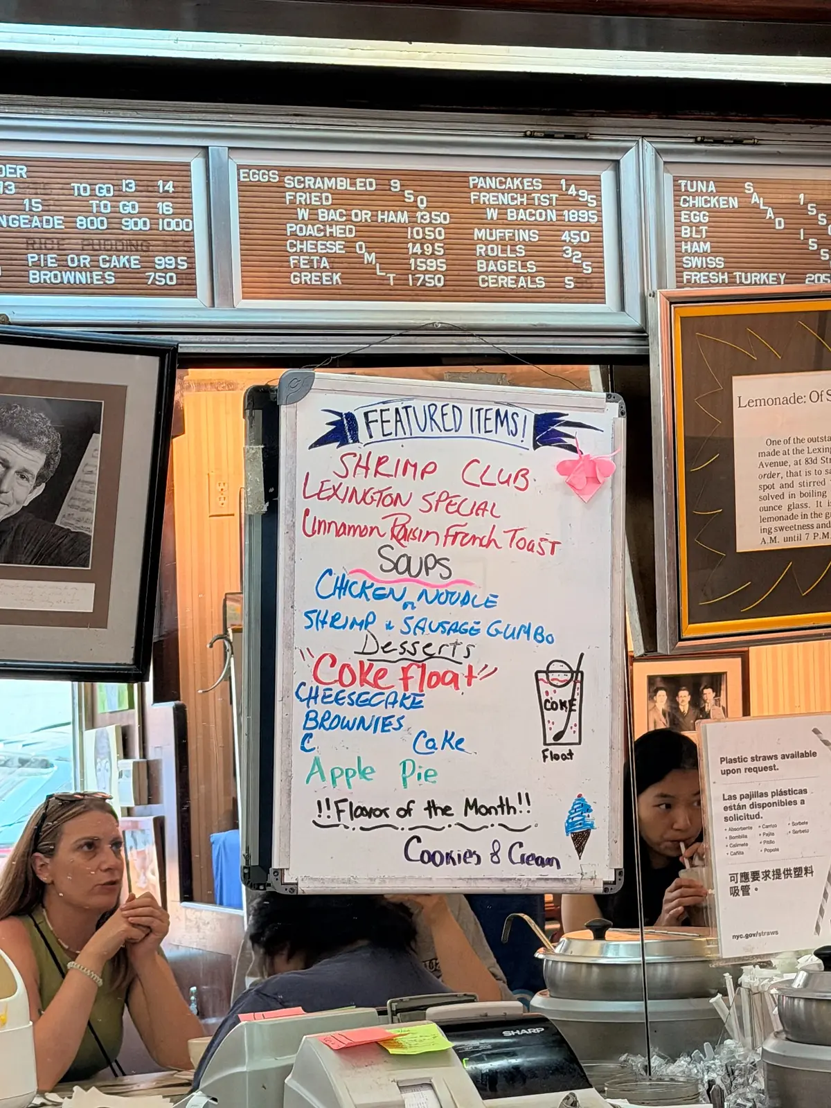 Close view of vintage letter-board menus and the handwritten featured-items board inside Lexington Candy Shop.