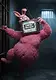 A fluffy pink rabbit character with an old television for a head showing static and the text ERROR! MAYHEM! posing inside a dark prison cell.