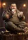 A stout, bearded man wearing a brown leather jacket and green shirt sitting cross-legged on a treasure chest, holding playing cards while one card is in his mouth, inside a dim room with a fireplace.