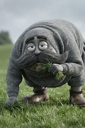 A round, gray creature with a large mustache and heavy eyelids bending over to eat grass in a meadow.