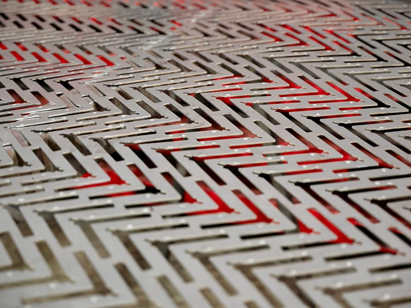 Perforated metal grate with chevron pattern
