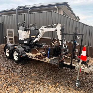 Bobcat E10 mini excavator — floated in with augers