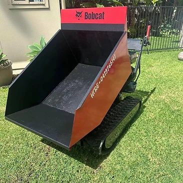 Tracked Bobcat mini dumper — tight backyard access