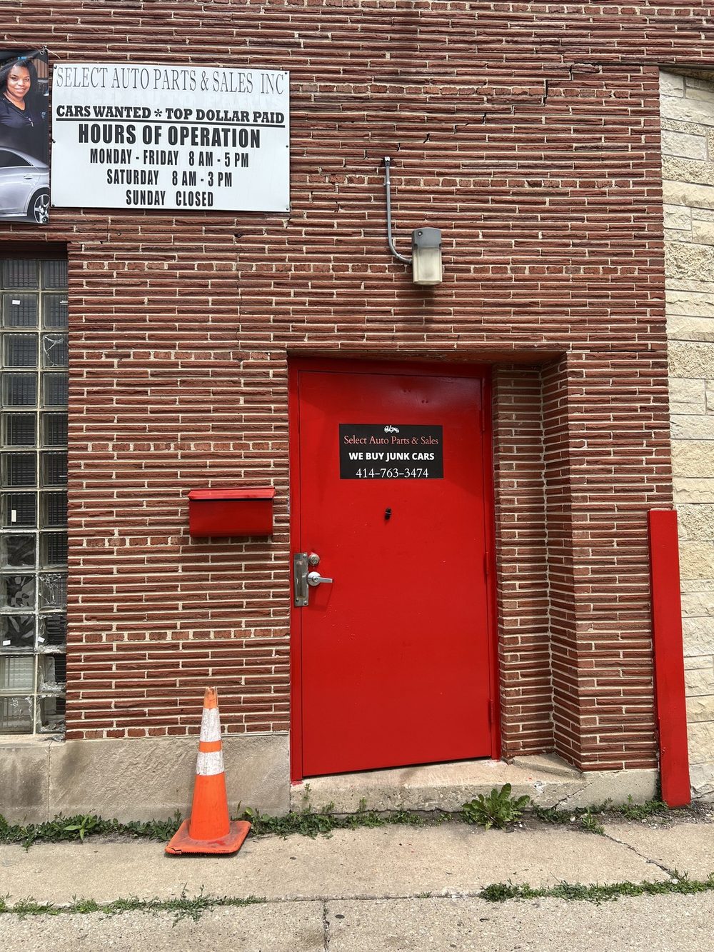 Natasha Broxton at the red office door inside Select Auto Parts and Sales, Milwaukee