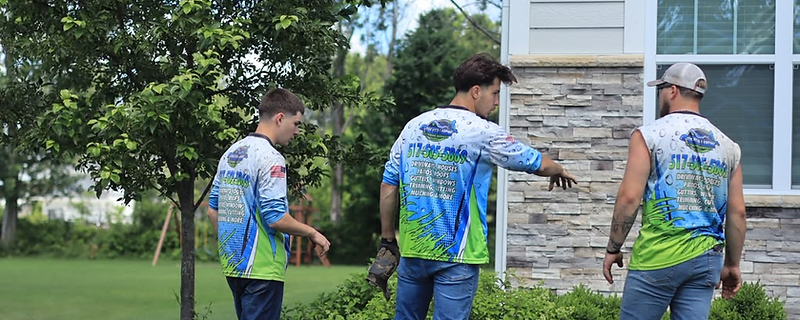 Greater Lansing Exterior Services crew in branded shirts on a residential jobsite