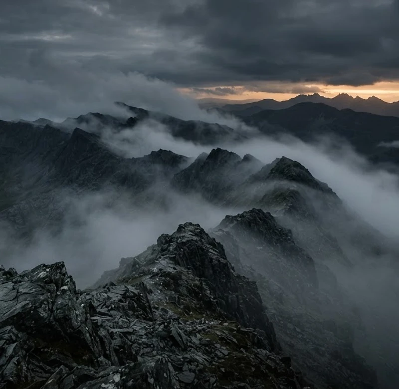 Welsh mountain ridge at dusk shrouded in fog