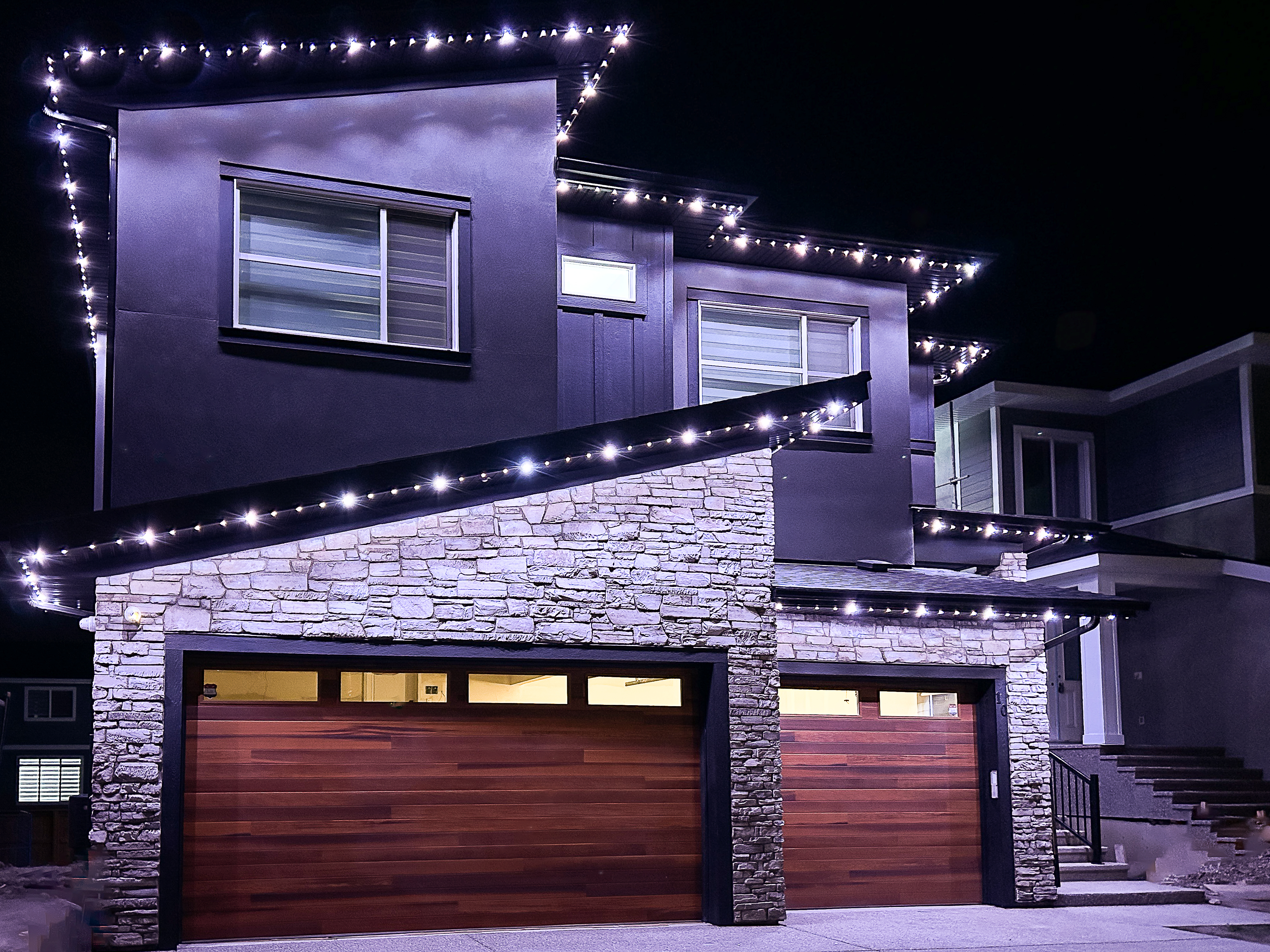 Permanent LED roofline lights on an Okanagan home at night