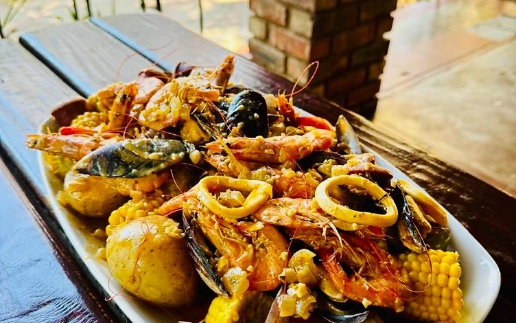 Signature seafood boil with shrimp, mussels, clams, lobster tails, corn and sausage