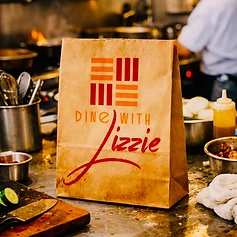 Every order leaves in a Dine with Lizzie bag — care packed in, start to finish.