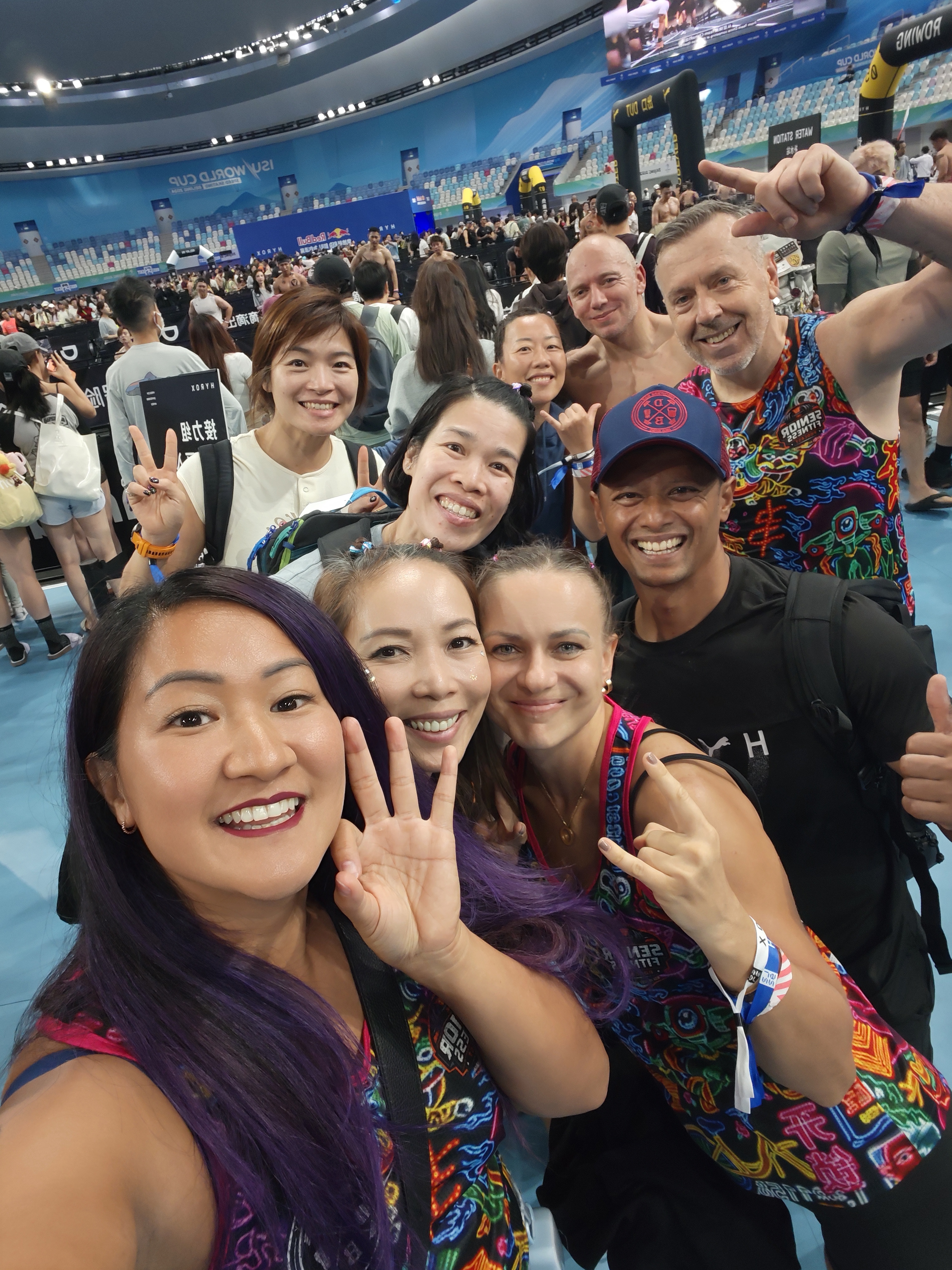 The DBDB crew, post-race, all smiles and neon tanks inside the Beijing arena.