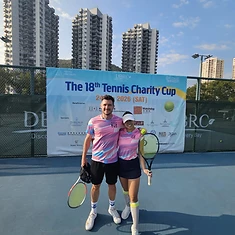Two DBDB Tennis Team members with rackets on court