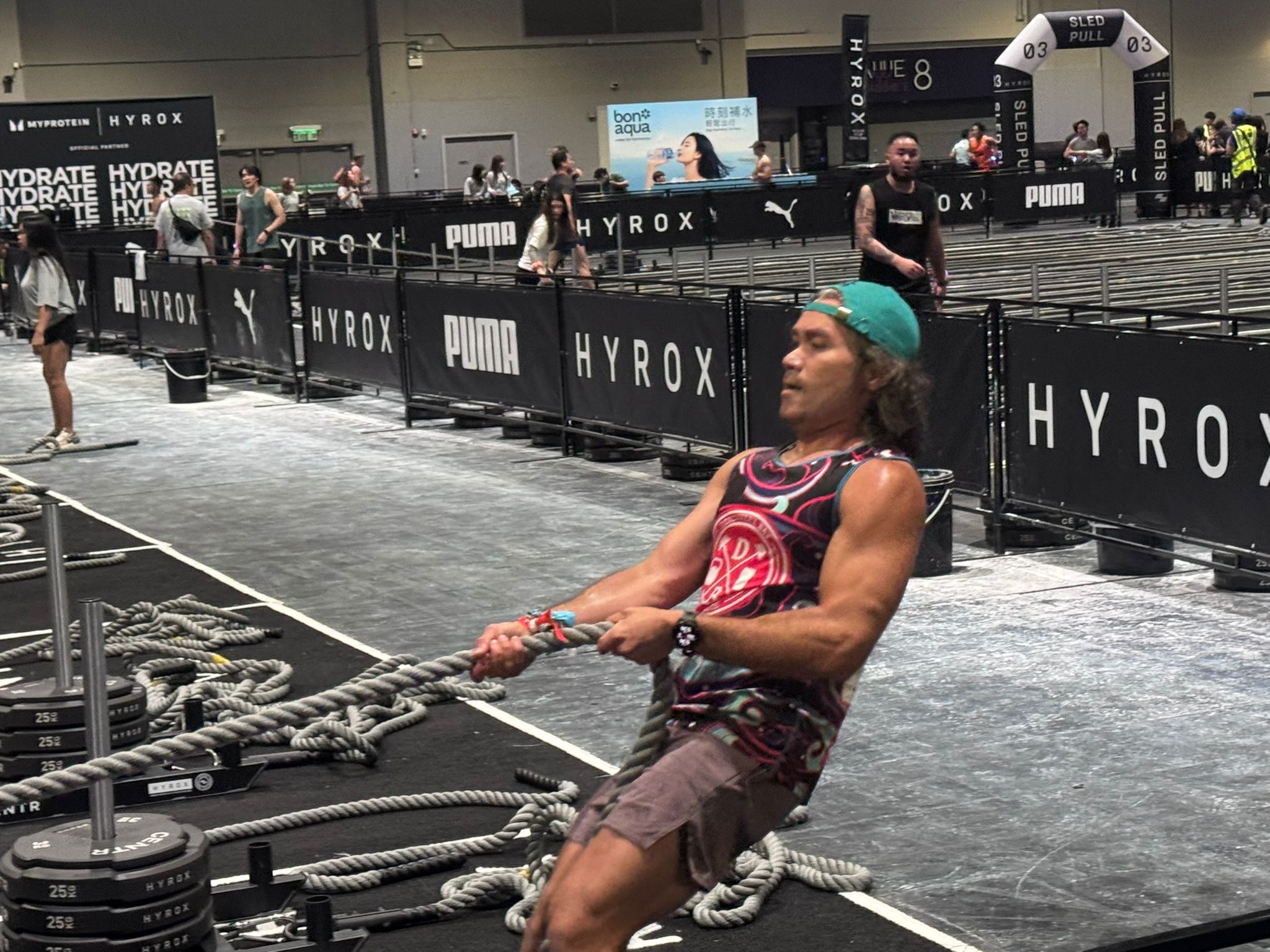A DBDB athlete mid rope pull on the HYROX course — the strength our training builds, put to work