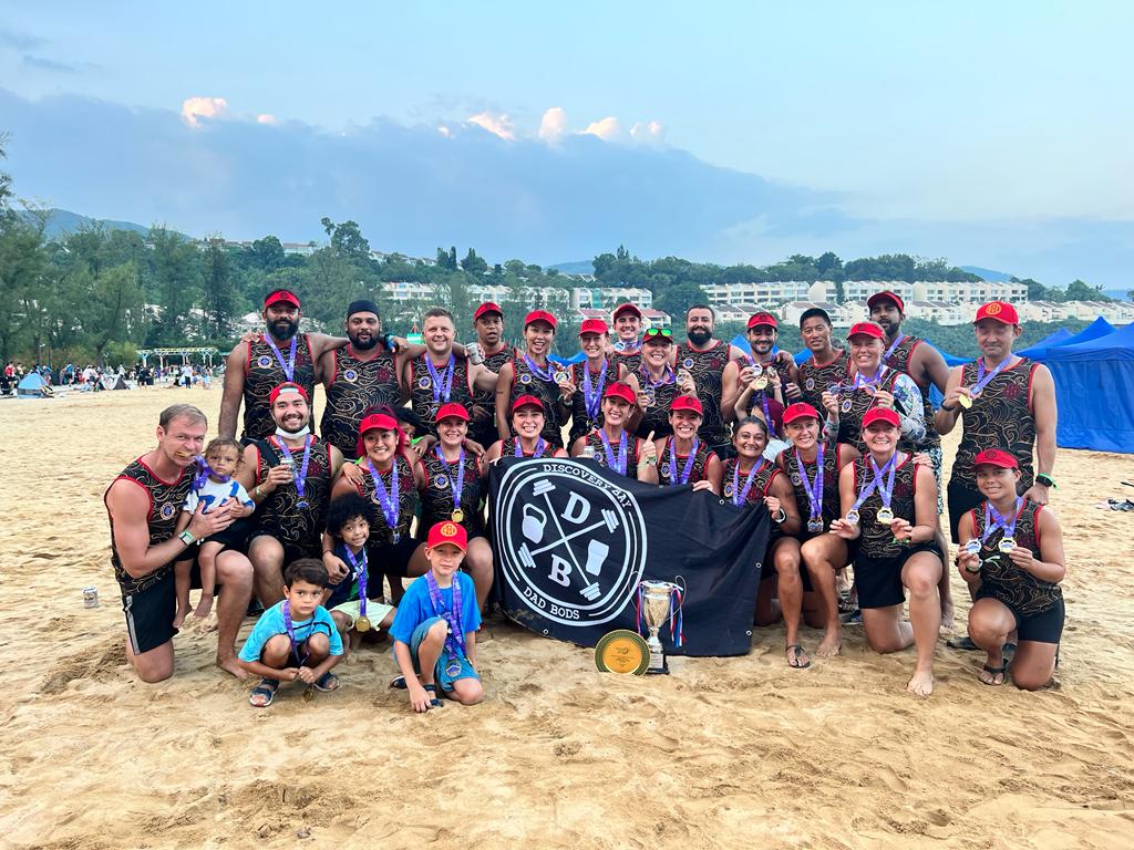 The DBDB crew celebrating with medals, banner and trophy after a winning Community Race performance