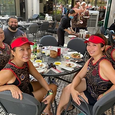 DBDB dragon boat crew in team gear enjoying a post-race meal together