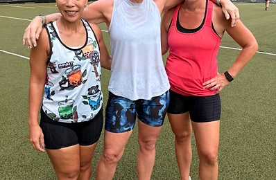 Three members linking arms after training