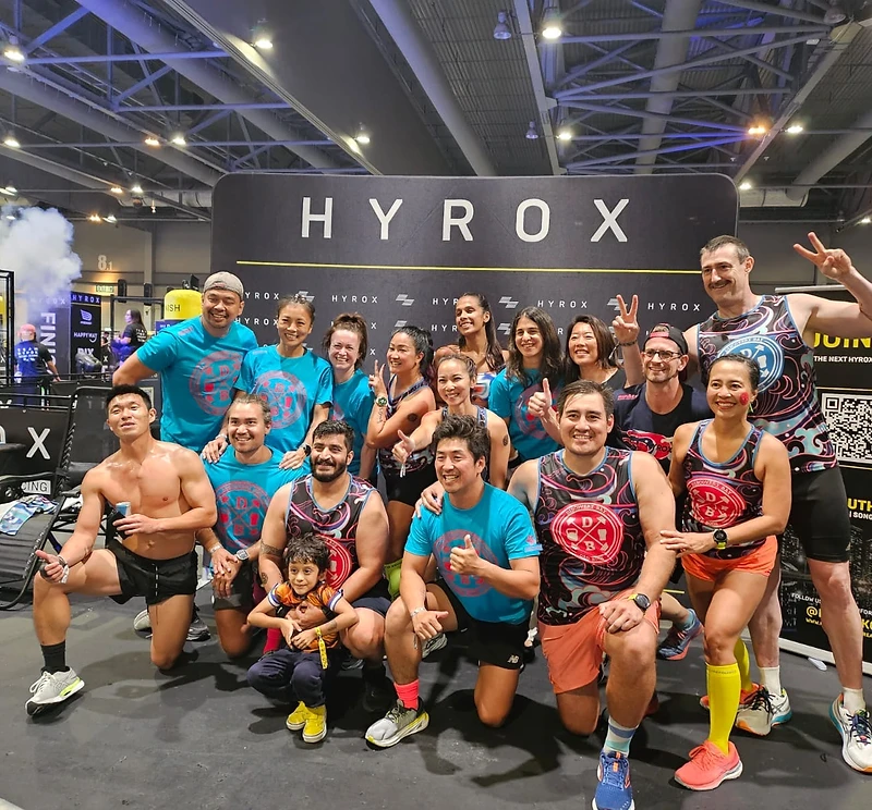 DBDB HYROX team posing in front of the HYROX backdrop