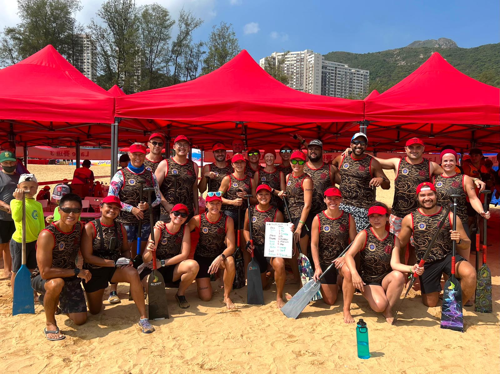 The DBDB Dragon Boat crew gathered under the event tents before heading to the water