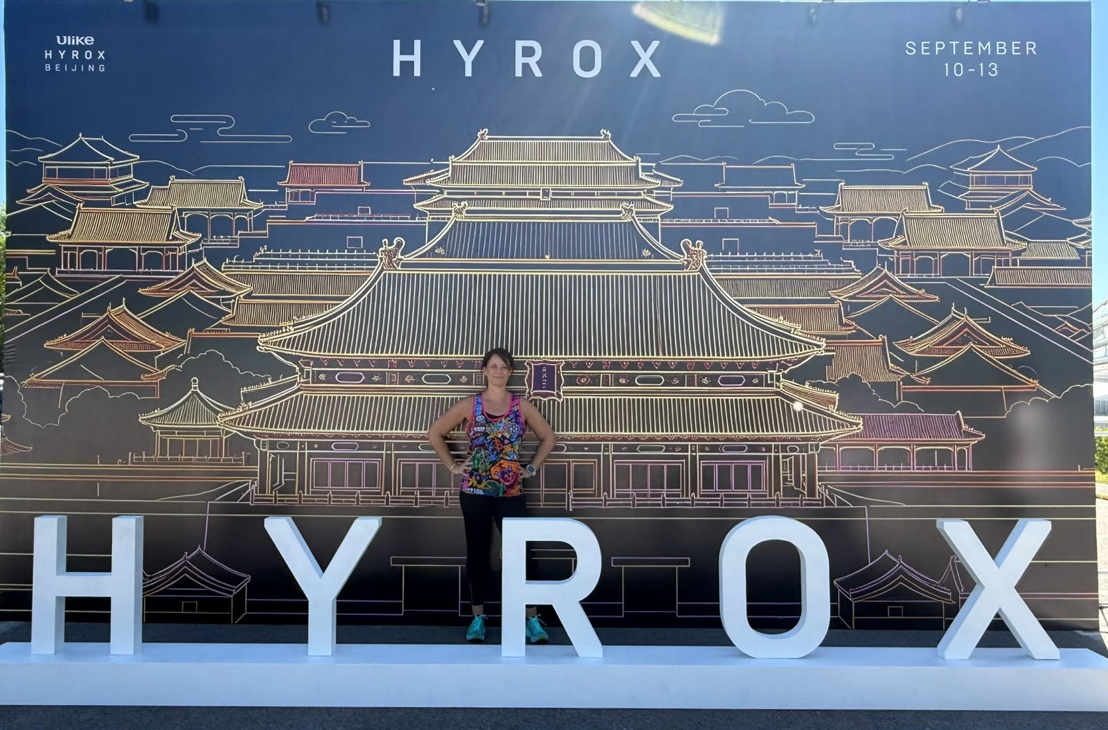 Hands on hips, heart full — one of the relay crew soaking in the Beijing finish line.