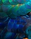 Diagonal divide of metallic green and gold scaled feathers over royal blue plumage, lit from the upper right.