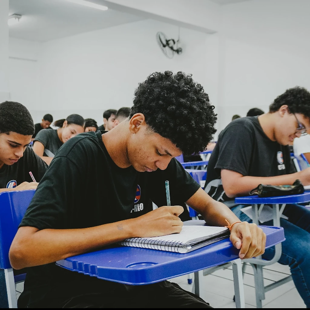 Aluno do CTRIO escrevendo em sala de aula