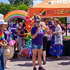 Speaker addressing the crowd at Pride in the Park under the Pride Halton tent at the Milton Fairgrounds