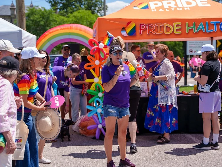 Pride in the Park festival with vendor tents and community booths