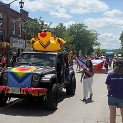 Jeep Wrangler with a large yellow inflatable duck participating in the Pride Halton parade on Main Street, Milton