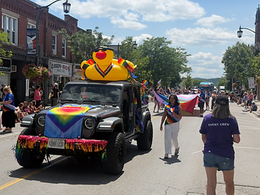 Jeep Wrangler with a large yellow inflatable duck participating in the Pride parade