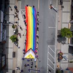 Aerial drone view of the Pride Halton 2026 parade crowd filling Main Street, Milton