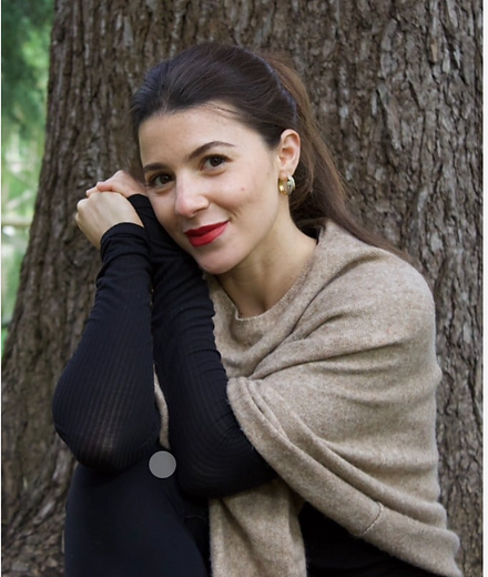 Portrait of Mira resting against a tree