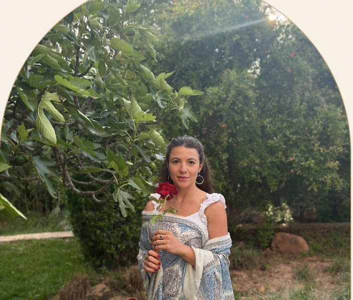 Mira holding a rose in the garden