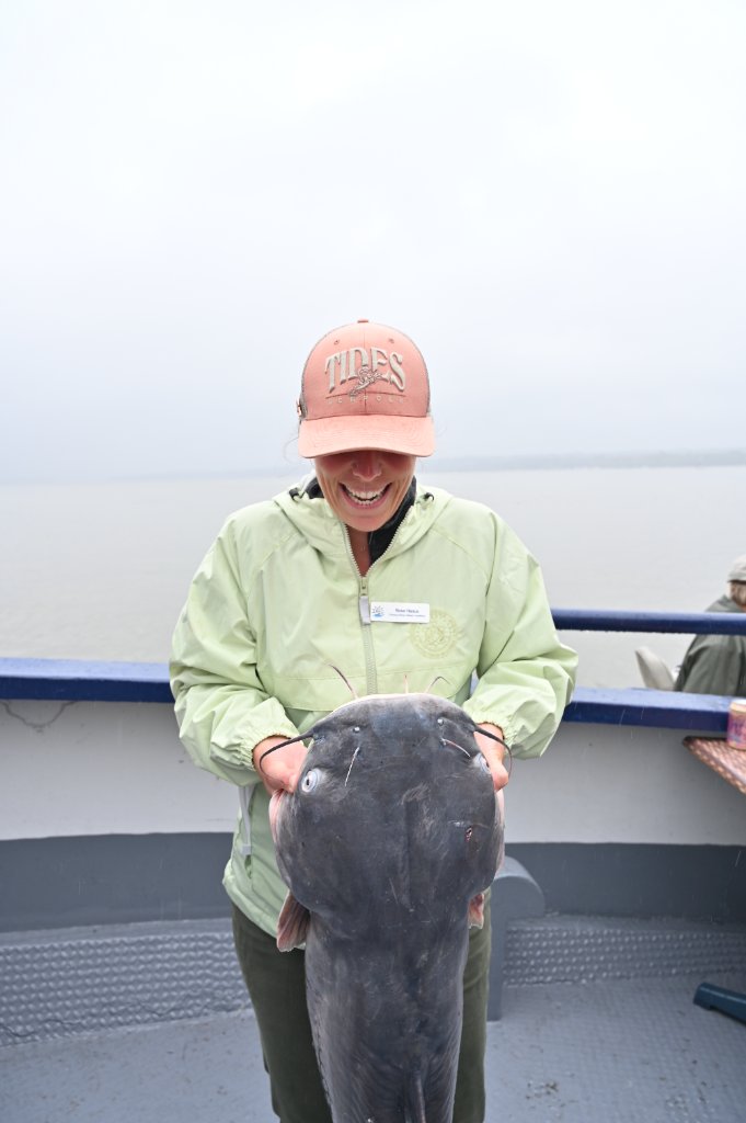 TIDES program participant holding a catfish on a boat