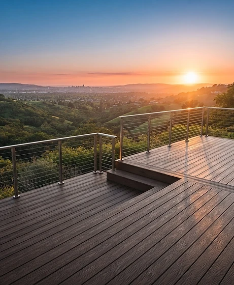 Luxury multi-level composite deck with steel cable railings overlooking a valley