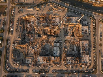 Top-down aerial view of a construction site at golden hour