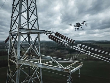 Aerial view of high-voltage powerline insulators being inspected