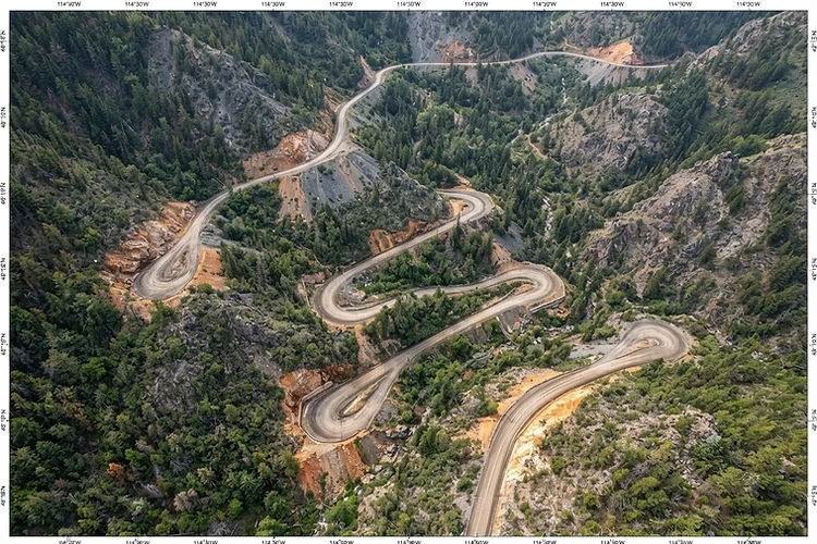 High-resolution aerial orthomosaic survey of a rural road with mapping coordinates
