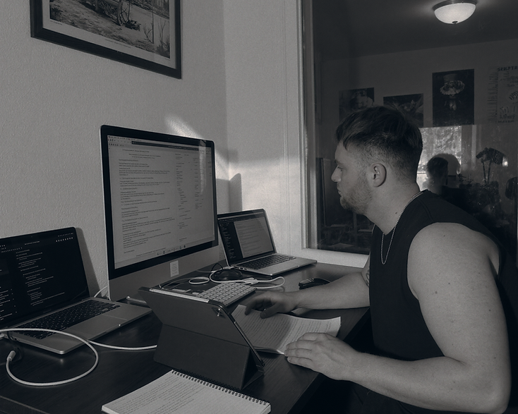 Amos Alexander working at a multi-screen product development setup
