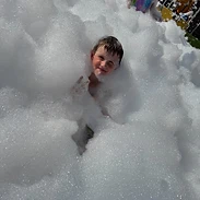 Child playing in foam