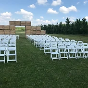 Outdoor wedding ceremony with crate altar