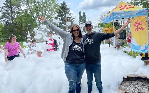 Couple enjoying a backyard foam party