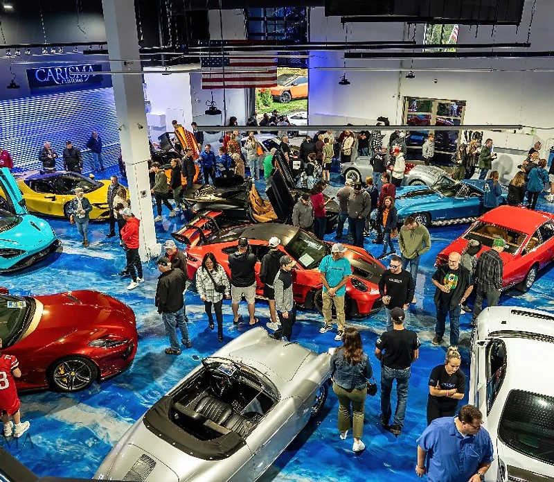 Carisma Customs car show floor filled with exotic and classic vehicles