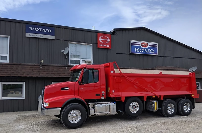 Red dump truck in front of Minto Truck Centre