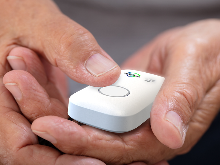 An older person holding the Sentinel Pulse, thumb resting on the help button