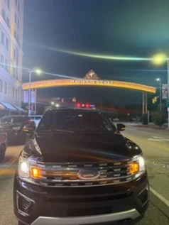 Black Ford Expedition beneath the Playhouse Square arch on Euclid Avenue at night