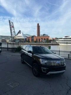 Ford Expedition beside the Cuyahoga River in the Flats at golden hour