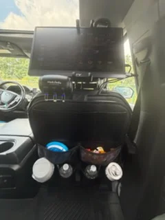 Headrest screen and seat-back organizer stocked with bottled water
