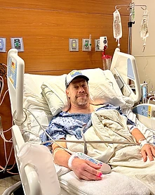Brian in a hospital bed during recovery
