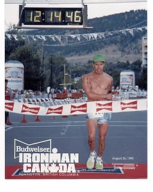 Brian breaking the finish line tape at Ironman Canada